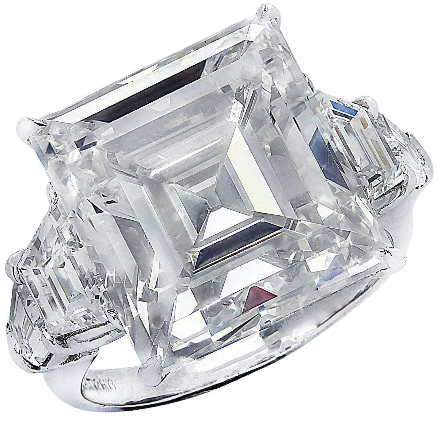 Exquisite 12.46ct Emerald Cut Diamond Engagement Ring in Platinum with Trapezoid Side Stones by Vivid Diamonds, showcasing a stunning emerald cut center stone surrounded by elegant trapezoid diamonds, crafted for the discerning bride.