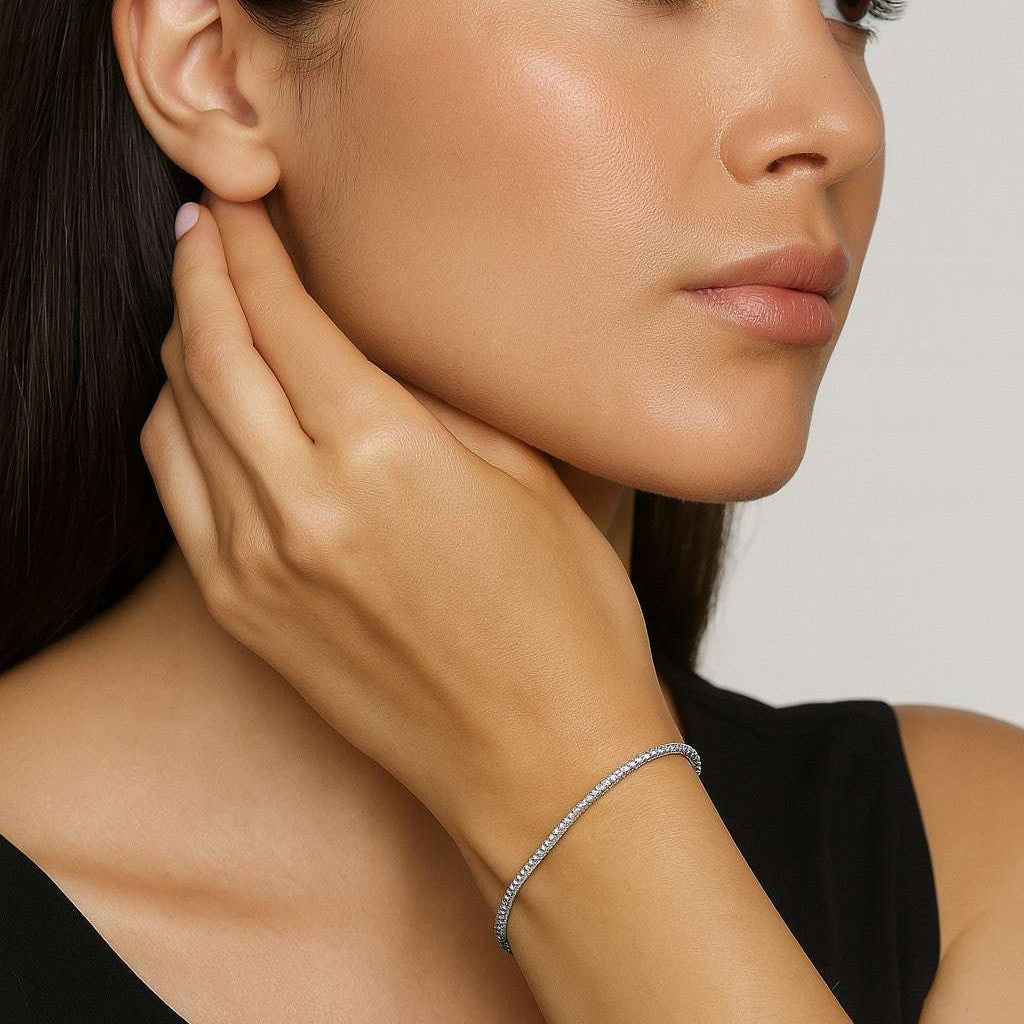 Elegantly showcasing the Stunning 14K White Gold Diamond Bracelet by Vivid Diamonds, worn on a model's wrist. This piece features 93 brilliant diamonds totaling 2.30 carats, exuding luxury and sophistication.
