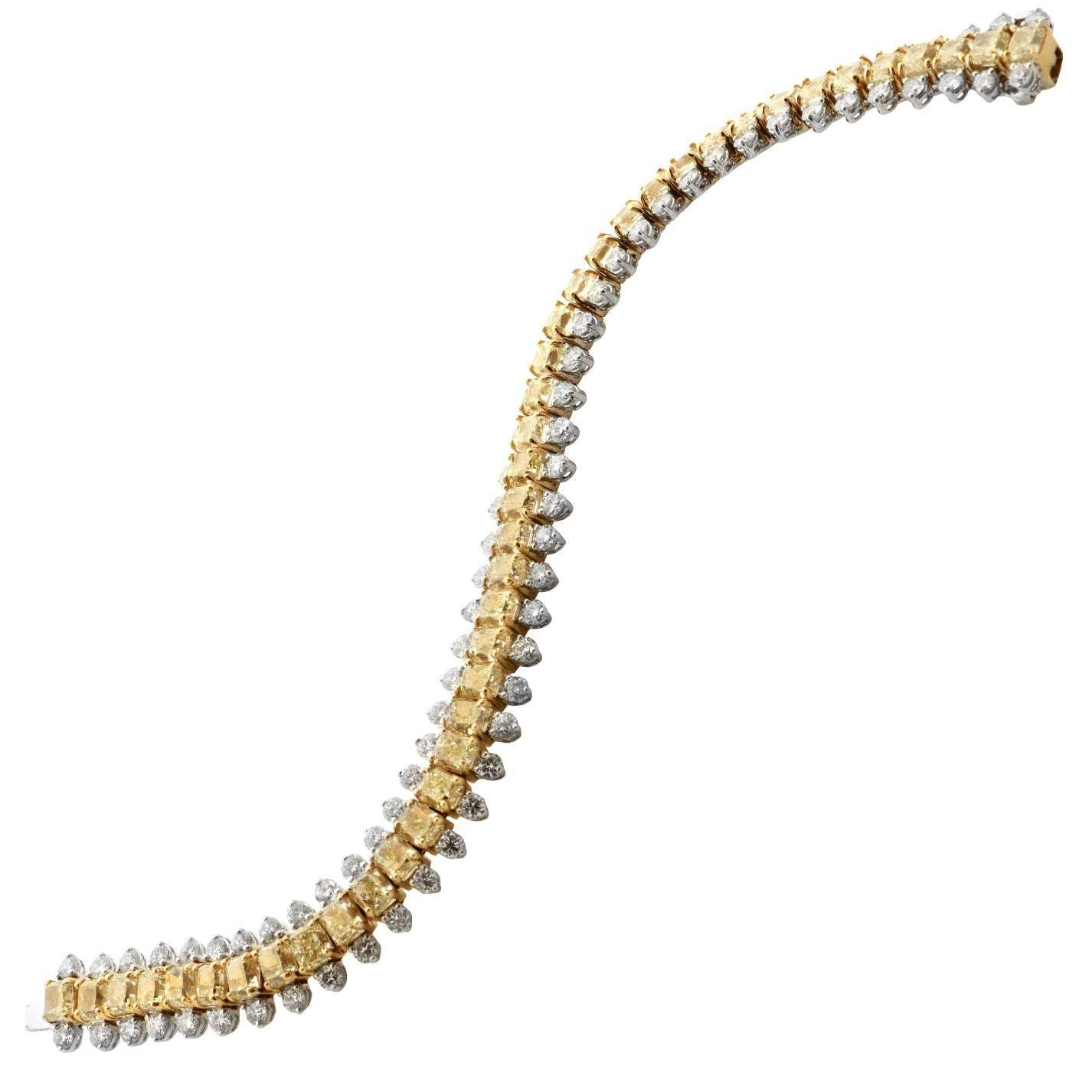 VIVID Color Diamond Bracelet showcasing 41 fancy yellow diamonds and 82 white diamonds in a luxurious 18K gold and platinum design by Vivid Diamonds, elegantly curved and dazzling.