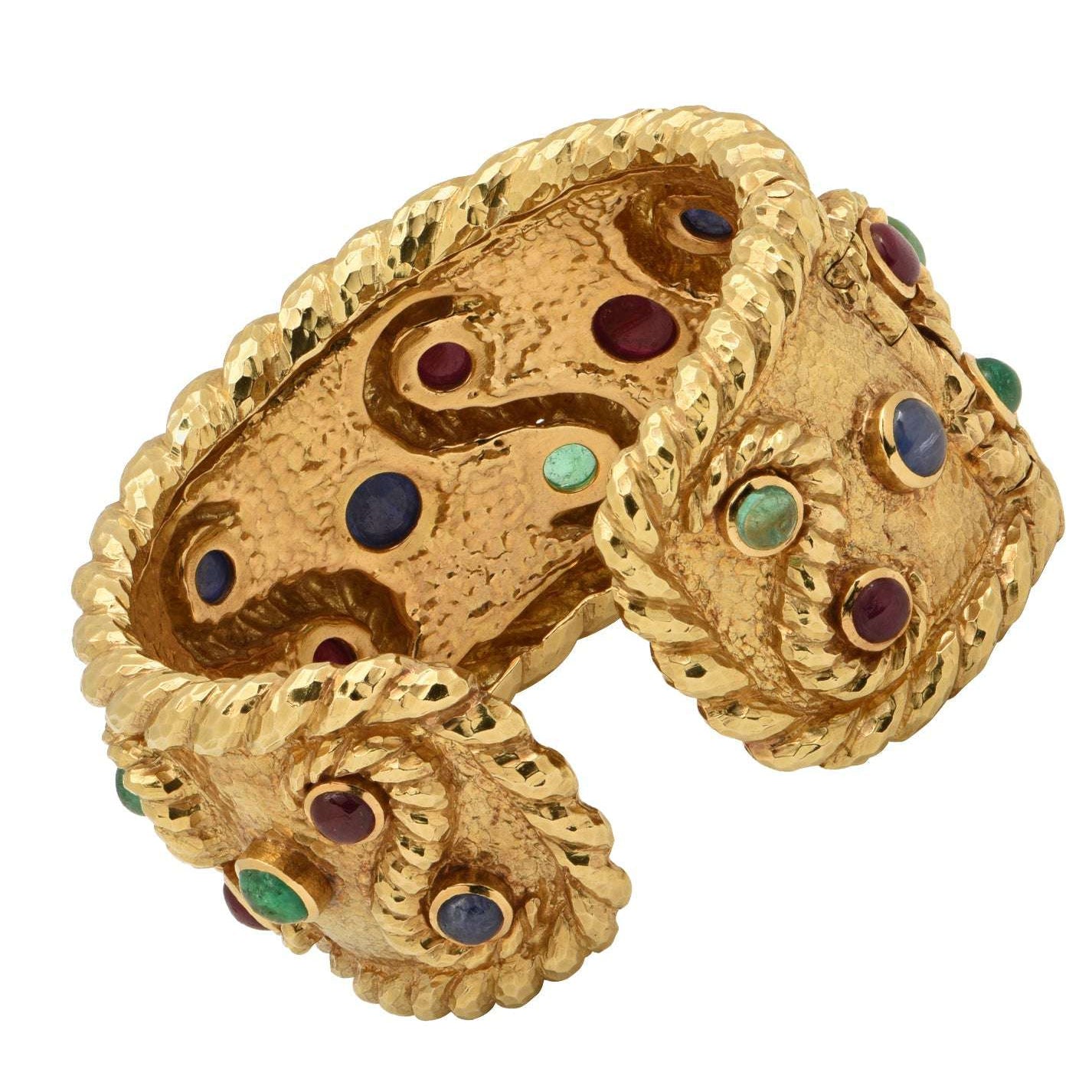 David Webb 18K Yellow Gold Cuff Bangle Bracelet featuring 6 Emeralds, 8 Rubies and 6 Sapphires, crafted by Vivid Diamonds, showcasing a unique hammered texture and vibrant cabochon gemstones.