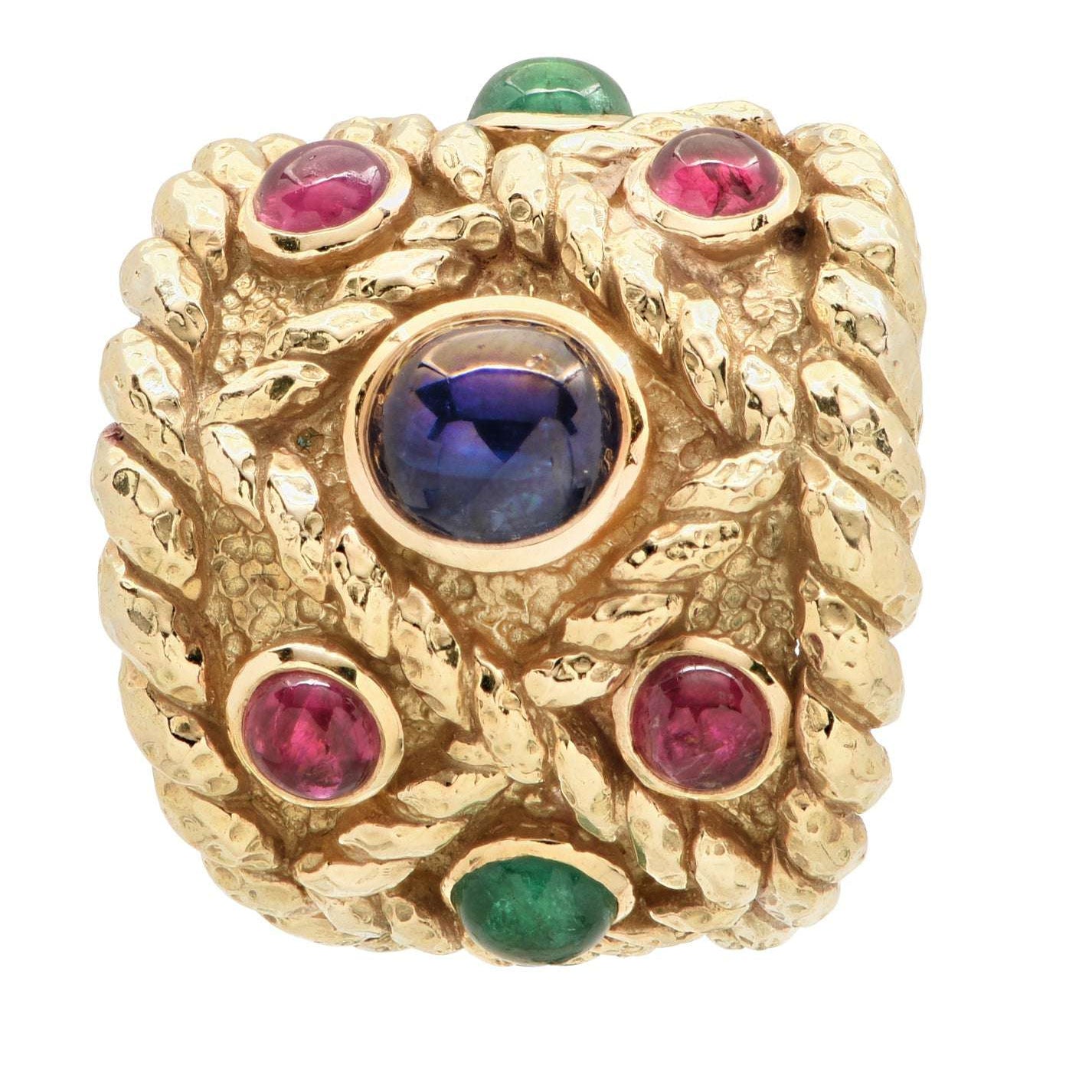 Luxury David Webb 18K Yellow Gold Ring featuring vibrant emeralds, rubies, and a sapphire, showcasing intricate hammered design, available at Vivid Diamonds.