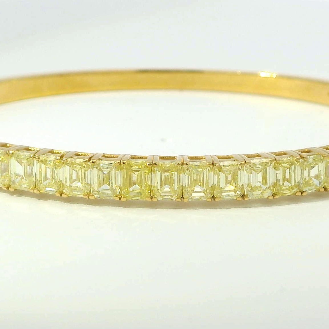 Elegant view of the 18K Yellow Gold Fancy Yellow Diamond Bracelet with a seamless setting of emerald-cut yellow diamonds, designed by Vivid Diamonds, epitomizing luxury and sophistication.
