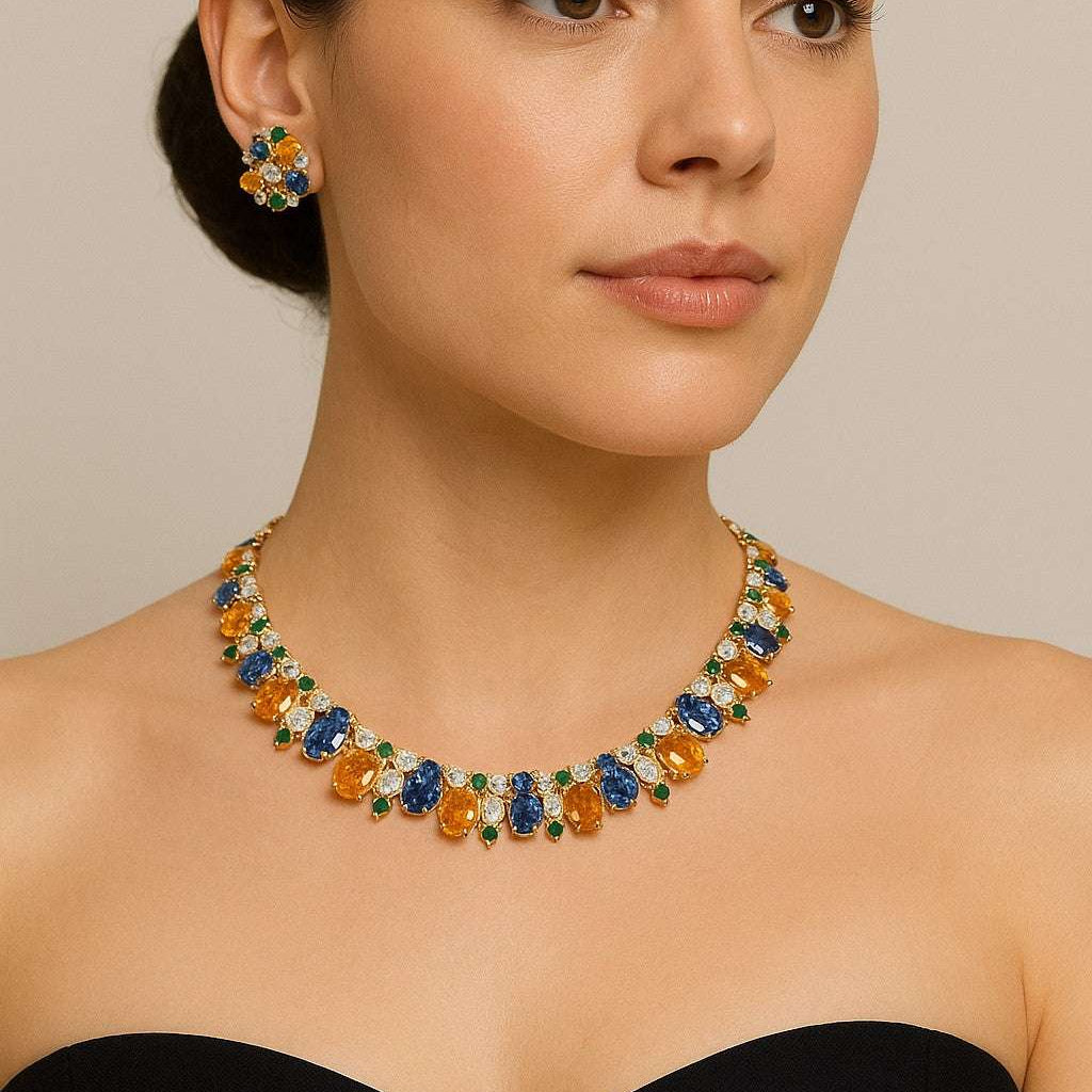 Exquisite mixed stone earring and necklace set by Vivid Diamonds, showcasing a stunning array of brilliantly cut blue sapphires, yellow sapphires, and sparkling diamonds, elegantly worn on a model.
