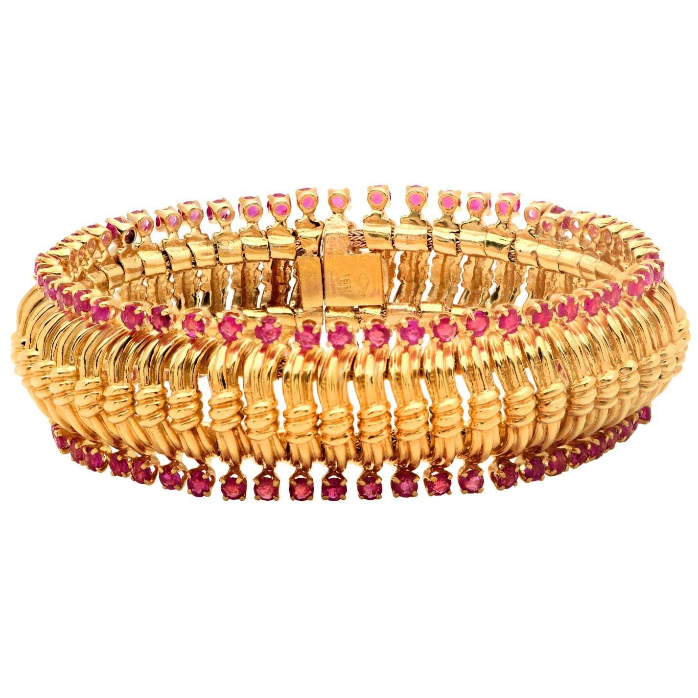 Stunning aerial view of the Exquisite Radiant Burma Ruby Bracelet in 18K gold with 102 diamonds, highlighting its luxurious design, available from Vivid Diamonds.