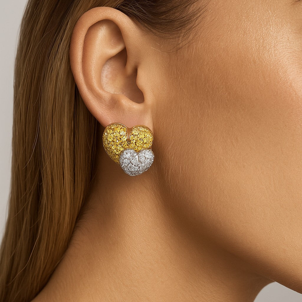 Elegant model wearing Salvetti 18K Two-Tone Gold Diamond Heart Earrings, highlighting their luxurious design and sparkling round diamonds, from Vivid Diamonds.