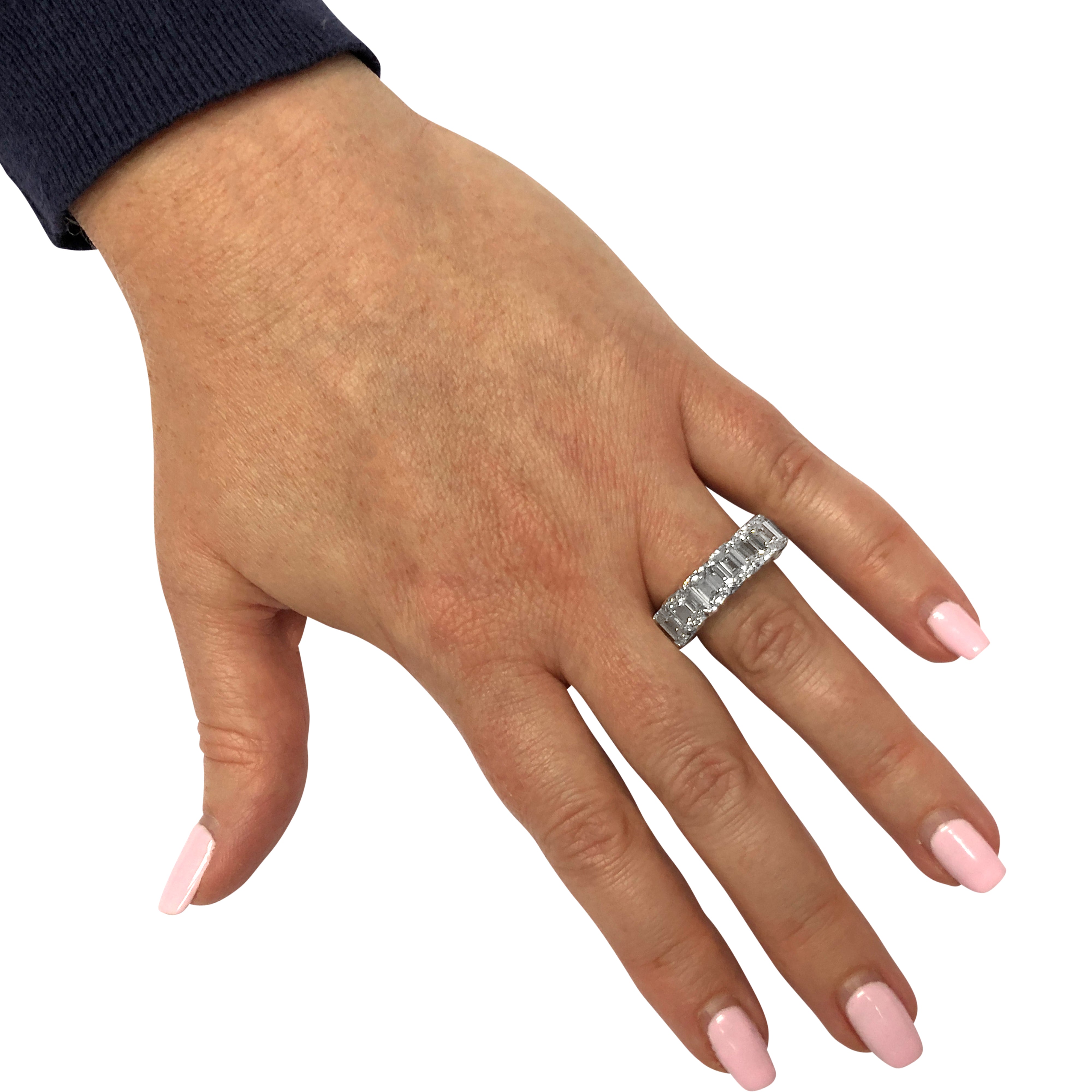 Worn view of the Vivid Diamonds 15.23 Carat Emerald Cut Diamond Eternity Band in Platinum on a hand, illustrating its luxurious design and elegant fit.