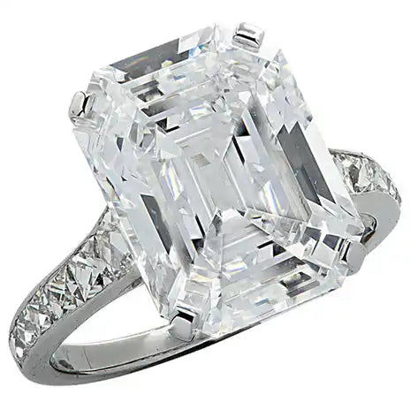 Emerald-cut diamond ring with pavé band.