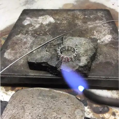 Silver ring being soldered.