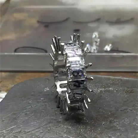 Unfinished diamond eternity ring.