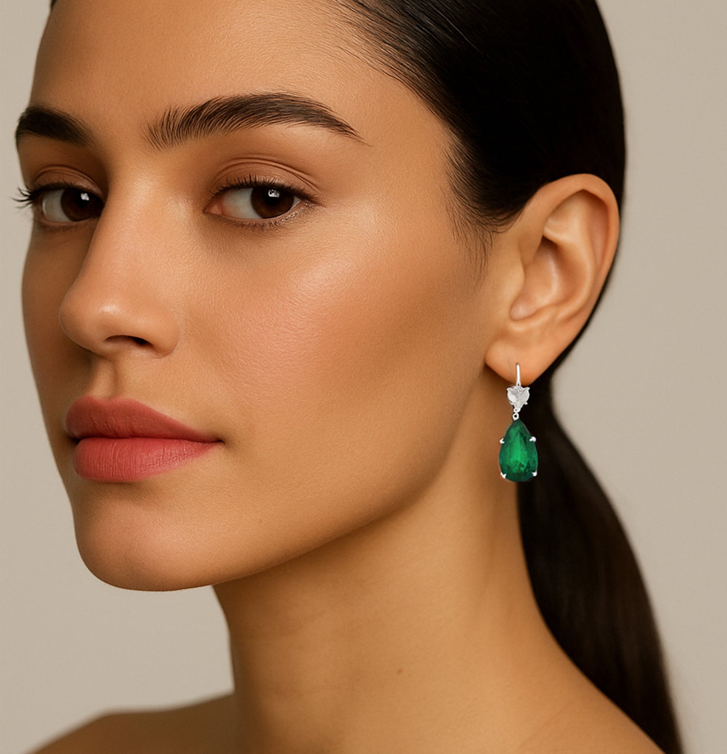 Elegant model wearing Vivid Diamonds GIA Certified 7.88ct Colombian Emerald & 2ct Diamond Dangle Earrings, emphasizing the stunning emerald color and luxurious design, perfect for enhancing beauty and sophistication.