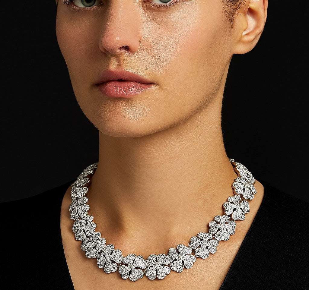 Sophisticated model displaying the Cartier Pave Diamond Clover Necklace from Vivid Diamonds, adorned with luminous diamond clovers in exquisite 18k white gold.