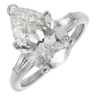 Exquisite 4.25ct Pear Diamond Platinum Ring with Baguette Accents by Vivid Diamonds, showcasing a stunning pear-shaped diamond center surrounded by elegant baguette accents, embodying luxury and sophistication.