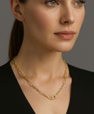 Model wearing the Timeless 18K Yellow Gold & 0.95 Carat Diamond Necklace by Vivid Diamonds, showcasing elegance and sophistication against a refined backdrop.