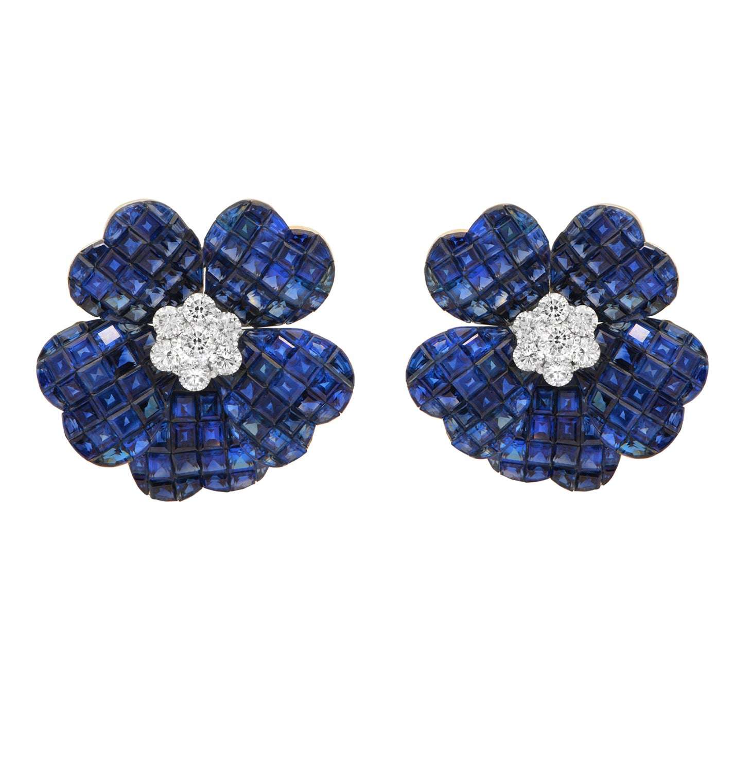 Luxurious 18k White Gold Sapphire & Diamond Floral Stud Earrings by Vivid Diamonds. Featuring exquisite square-cut sapphire petals in royal blue, with a center cluster of brilliant round diamonds, showcasing elegance and artistry in jewelry design.