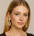Elegant model showcasing the Stunning 18K Yellow Gold Pearl & 7.50 Ct Diamond Earrings by Vivid Diamonds, highlighting their luxurious design and intricate craftsmanship.