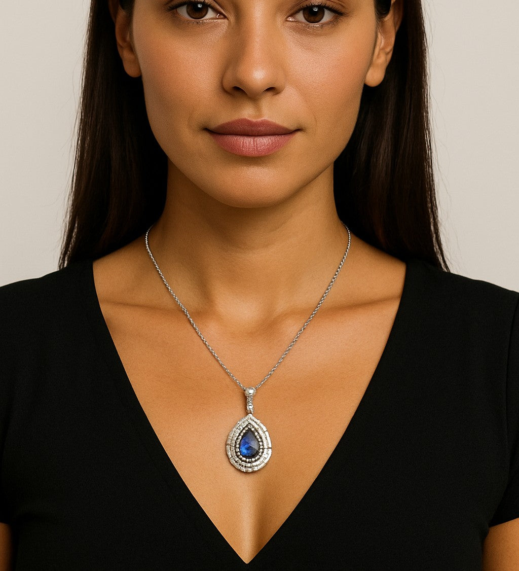 Model wearing a 1.94Ct Pear-Shaped Sapphire Necklace in White Gold Surrounded by 52 Diamonds by Vivid Diamonds, elegantly highlighting the luxurious design on a deep V-neckline.