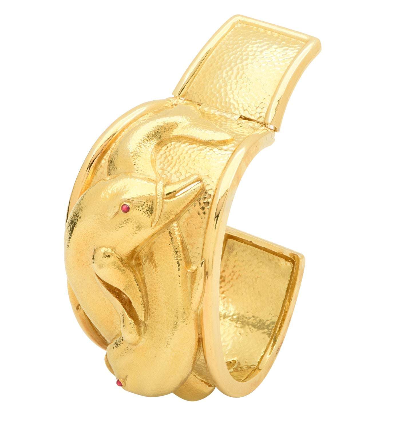 David Webb 18K Yellow Gold Dolphin Cuff Bangle with Ruby Accents, an exquisite designer jewelry piece by Vivid Diamonds, featuring intricately designed dolphins and vibrant ruby eyes, perfect for adding luxury to any collection.