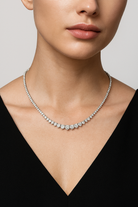 Luxurious 12ct White Gold Diamond Necklace by Vivid Diamonds, displayed elegantly on a model, emphasizing its timeless design and sparkling diamond brilliance.