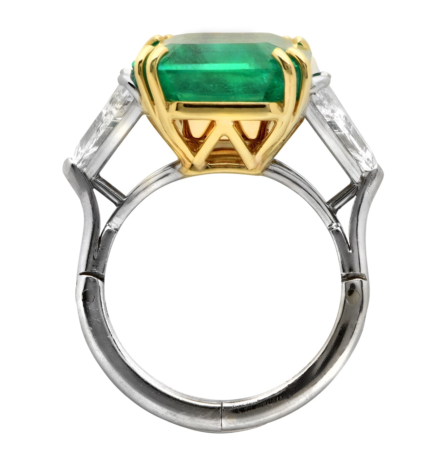 Side view of the exquisite 10.14Ct Vivid Green Emerald & 2Ct Trillion Diamond Ring in Platinum & 18K Yellow Gold by Vivid Diamonds, highlighting the unique setting and design elegance.