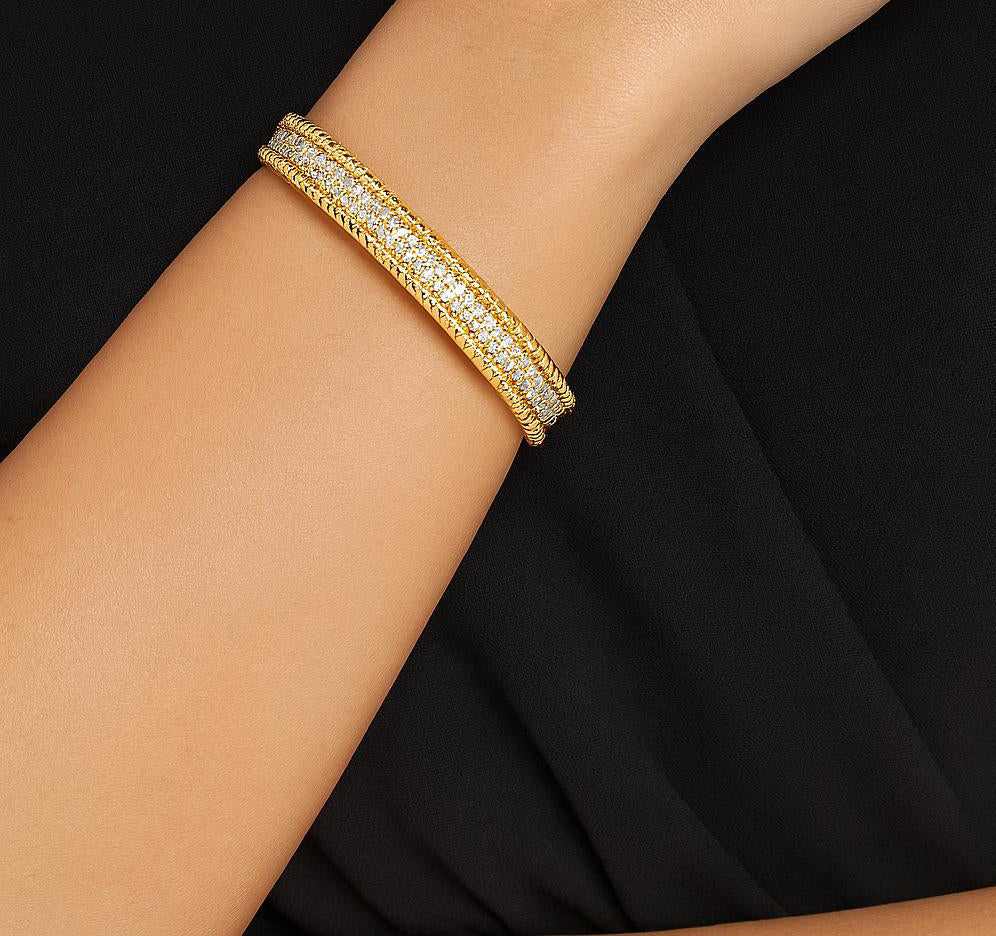 Elegant hand wearing the Exquisite 293-Diamond 18K Yellow Gold Bracelet by Vivid Diamonds, highlighting its stylish design and luxurious shine.
