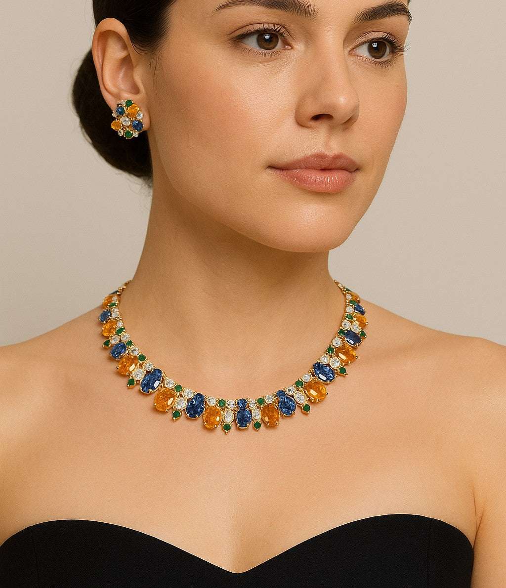 Exquisite mixed stone earring and necklace set by Vivid Diamonds, showcasing a stunning array of brilliantly cut blue sapphires, yellow sapphires, and sparkling diamonds, elegantly worn on a model.