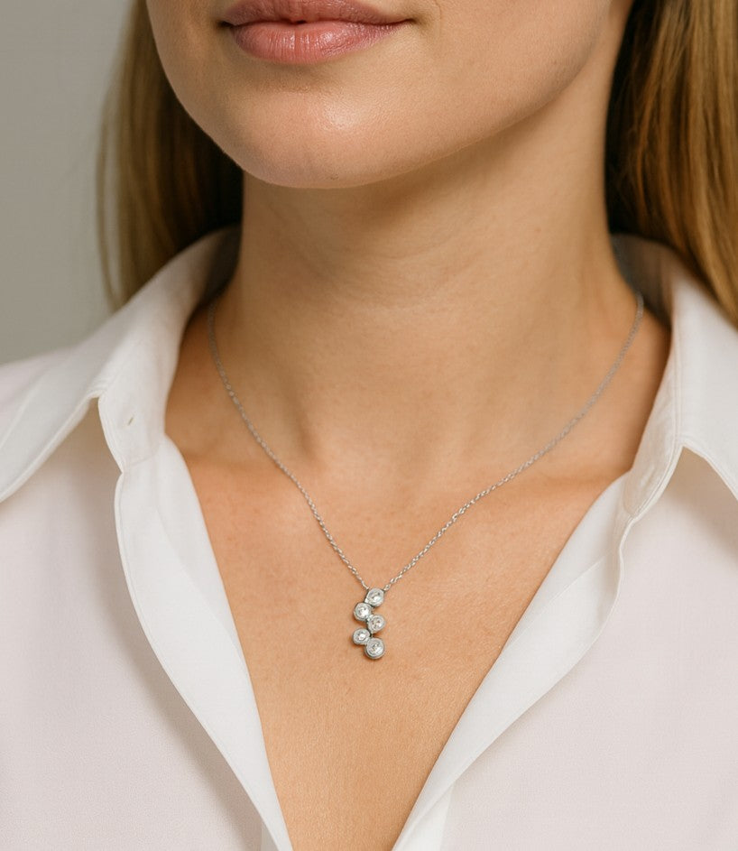Model showcasing the 14k White Gold Diamond Necklace by Vivid Diamonds, featuring five sparkling round brilliant cut diamonds, perfect for everyday elegance.