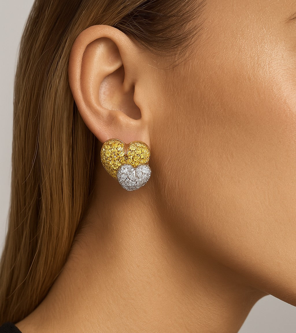 Elegant model wearing Salvetti 18K Two-Tone Gold Diamond Heart Earrings, highlighting their luxurious design and sparkling round diamonds, from Vivid Diamonds.