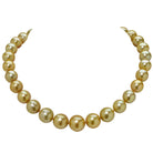 Stunning 12-16MM Gold South Sea Pearl Necklace by Vivid Diamonds featuring a luxurious design and vibrant golden hues, secured with a 14K yellow gold clasp. This elegant jewelry piece exemplifies luxury and sophistication.