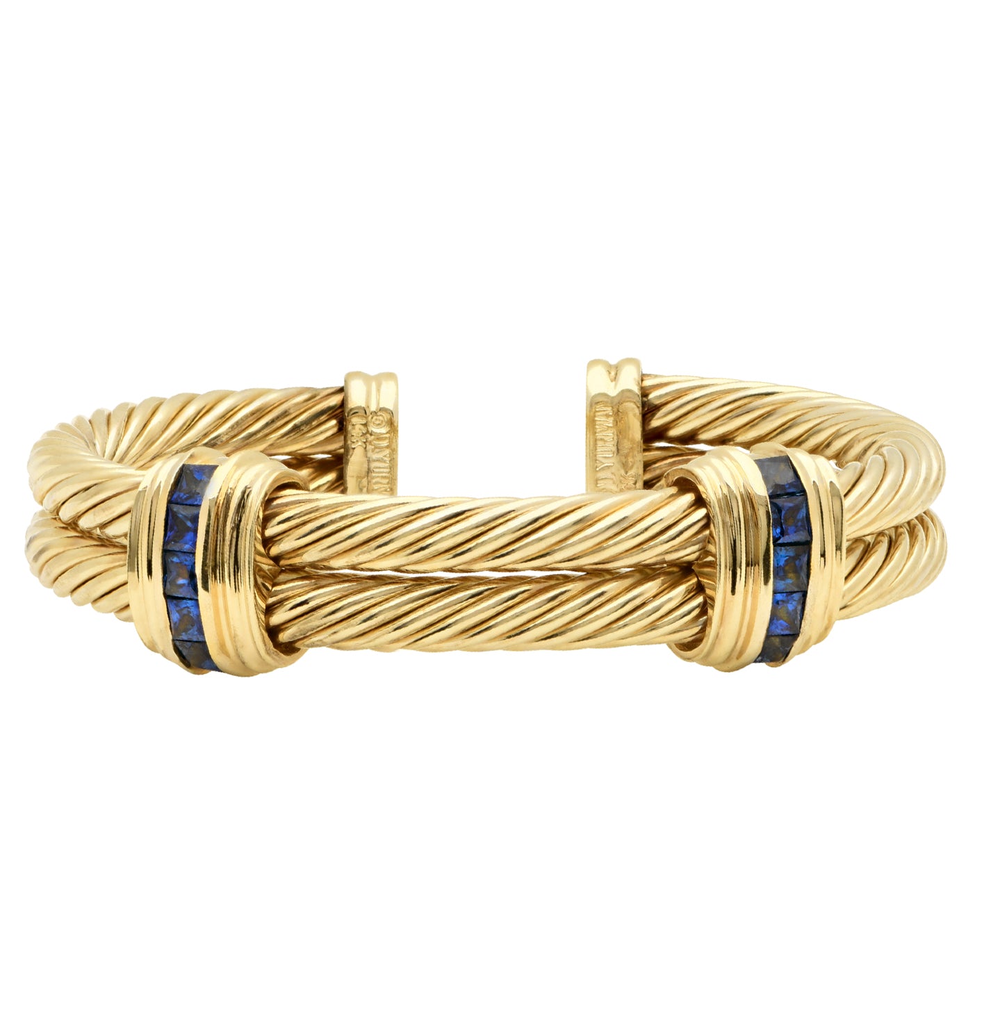 Side view of David Yurman 18k yellow gold bangle featuring baguette-cut blue sapphires and signature cable twist design